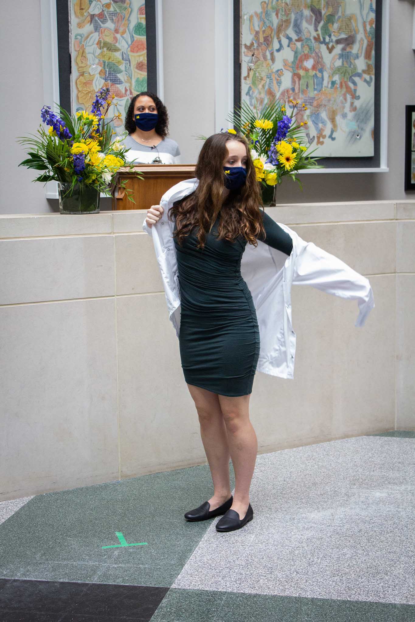 student receiving white coat