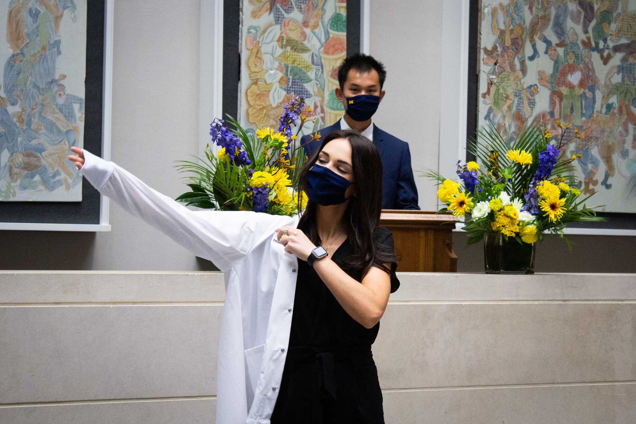 student receiving white coat