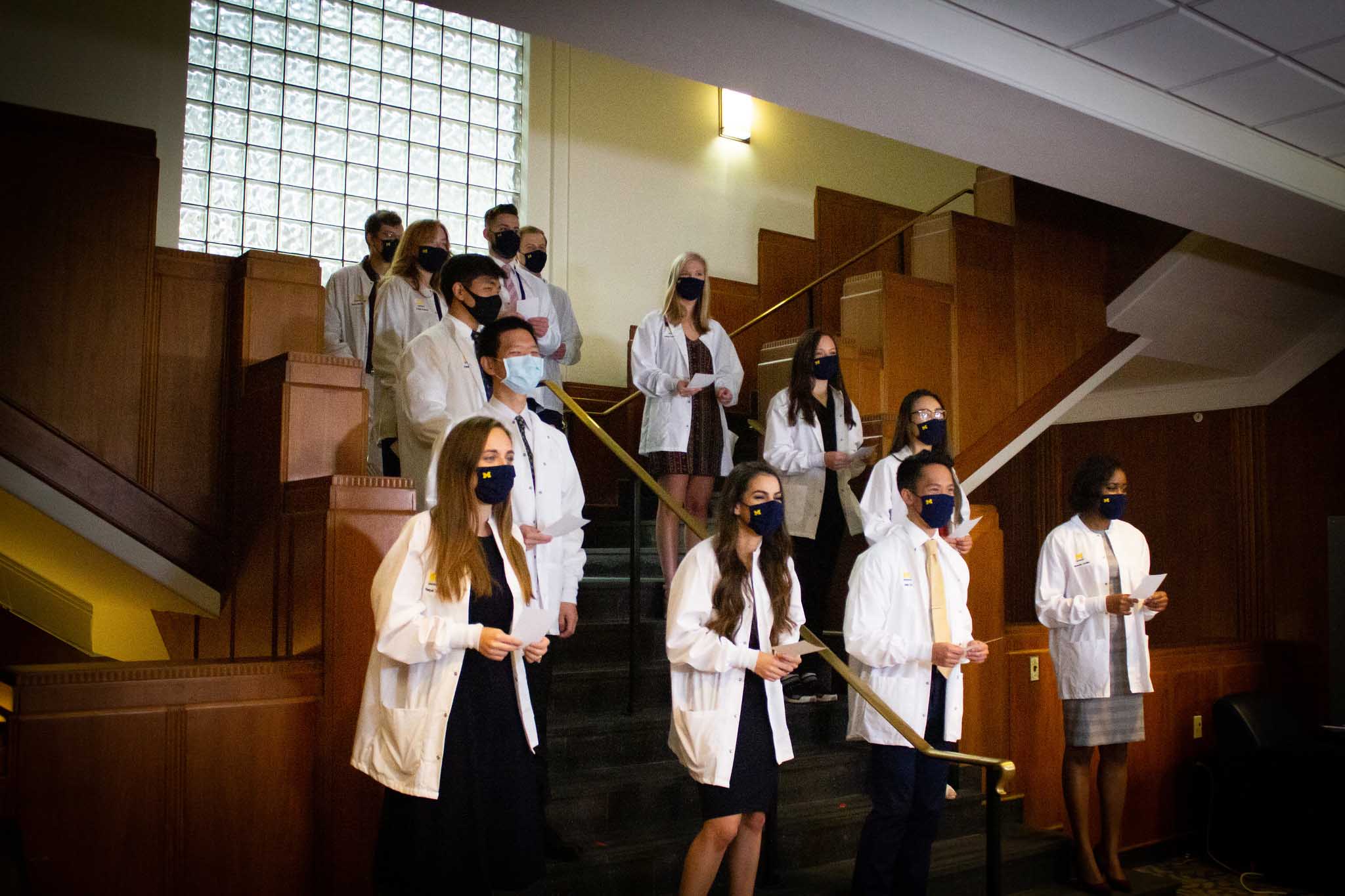 student receiving white coat