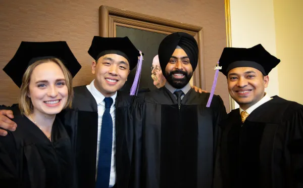 four graduates posing for a picture